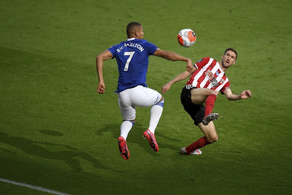 Chris Basham ketika mencoba menghentikan pergerakan Richarlison. (c) AP Photo