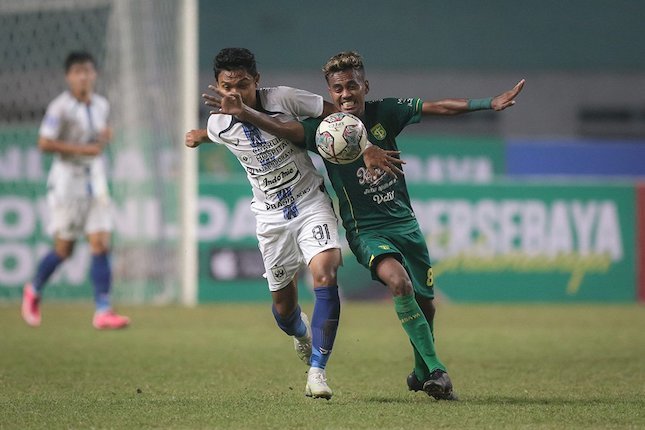 Pemain PSIS Semarang, Fandi Eko Utomo (kiri) dan pemain Persebaya Surabaya, Muhammad Alwi Slamat berebut bola saat laga pekan keenam BRI Liga 1 2021/2022 (c) Bola.net/Bagaskara Lazuardi