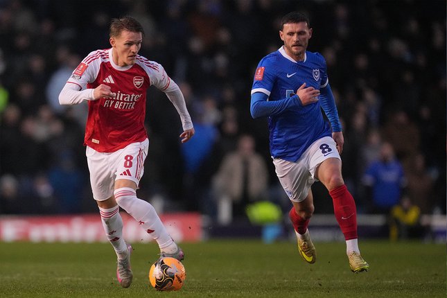 Gelandang Arsenal, Martin Odegaard dibayangi pemain Portsmouth, John Swift di laga Piala FA, 11 Januari 2026. (c) AP Photo/Kin Cheung