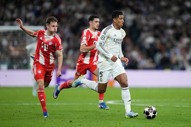 Kembalinya Jude Bellingham Gelandang Bayern Munchen, Joshua Kimmich (kiri) mencoba menghentikan pergerakan gelandang Real Madrid, Jude Bellingham pada leg I perempat final Liga Champions, 8 April 2026. (c) AP Photo/Bernat Armangue