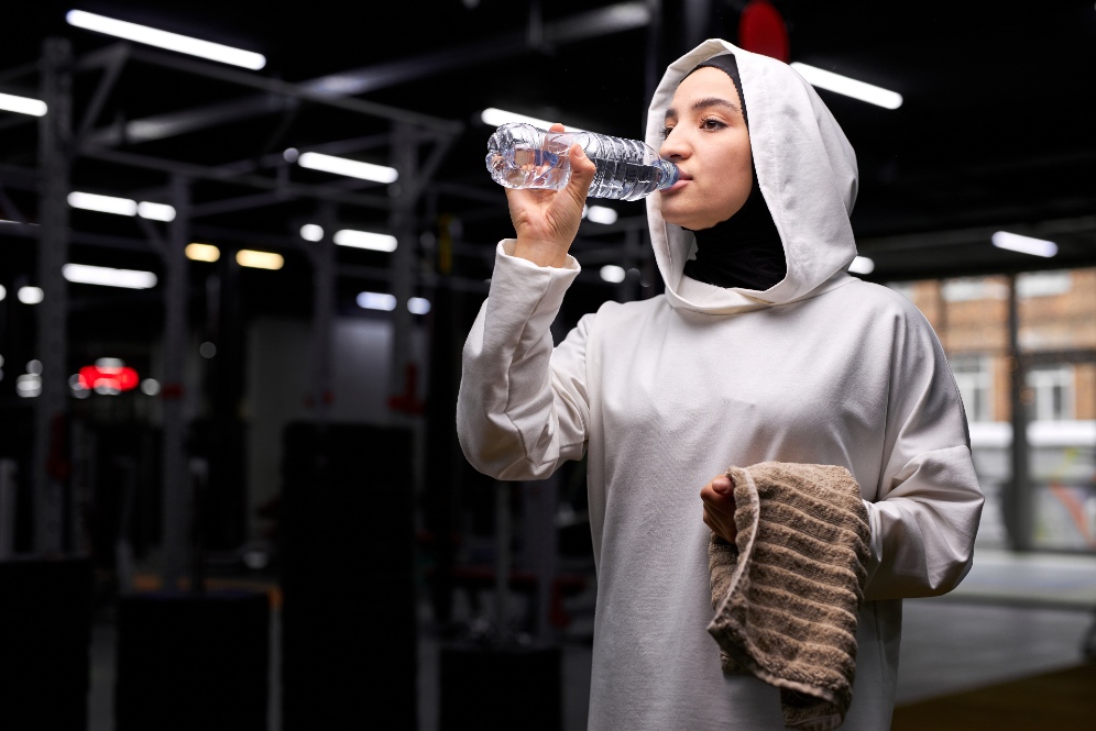 Woman in hijab drinking water