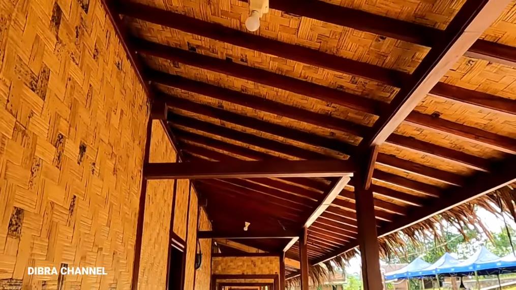 Humble house with ijuk roof and bamboo woven walls.