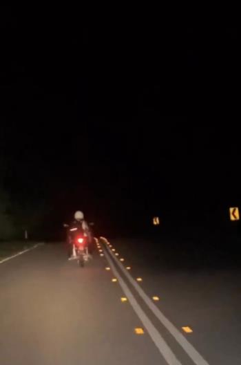 Girl's action of providing lighting for a grandfather's motorcycle without a front light.