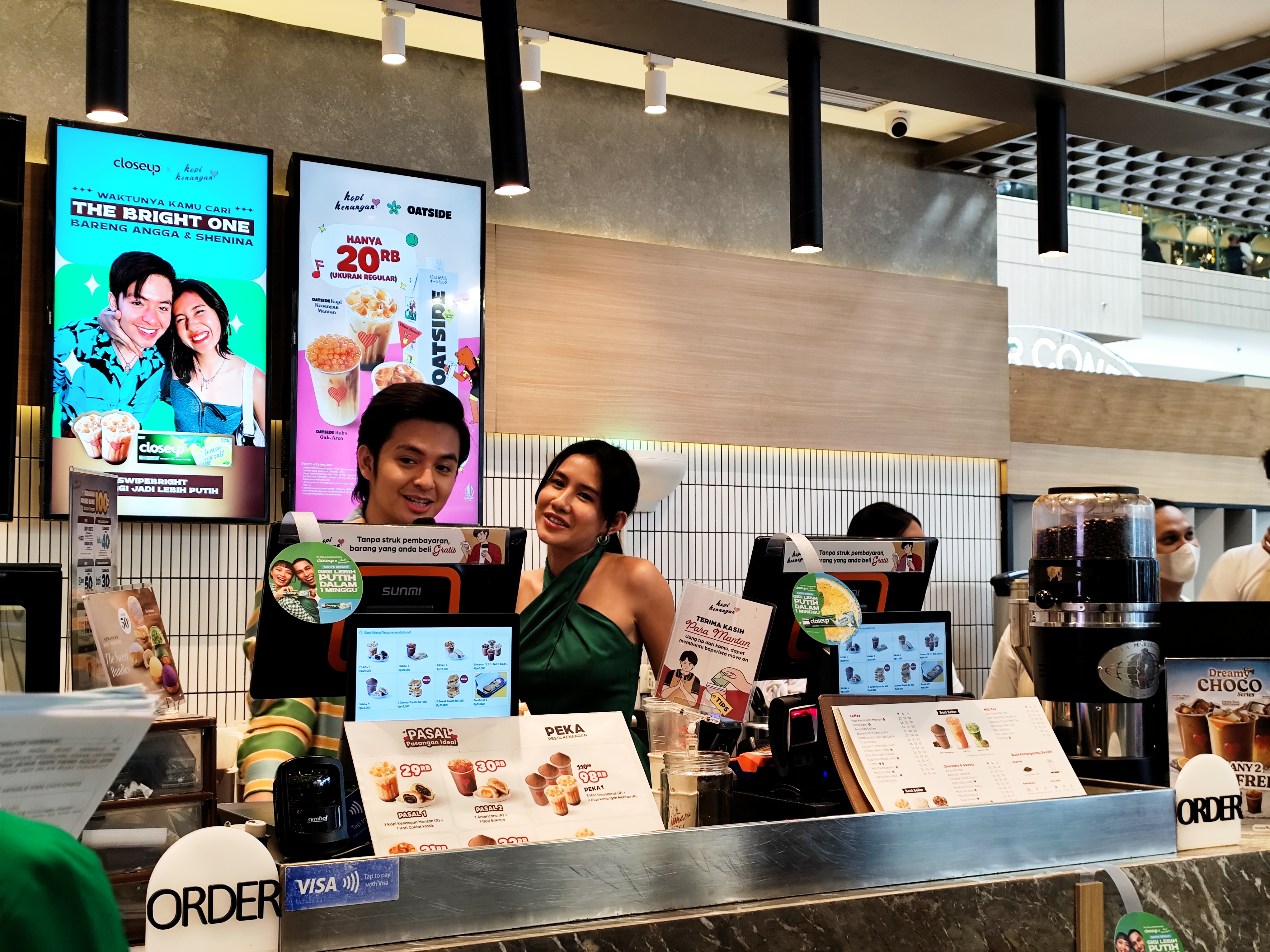 Angga Yunanda and Shenina Cinnamon as cashiers at Kopi Kenangan.