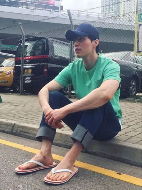 Lee Dong Wook bikin fans gagal fokus karena duduk di trotoar pinggir jalan. ©Instagram/leedongwook_official