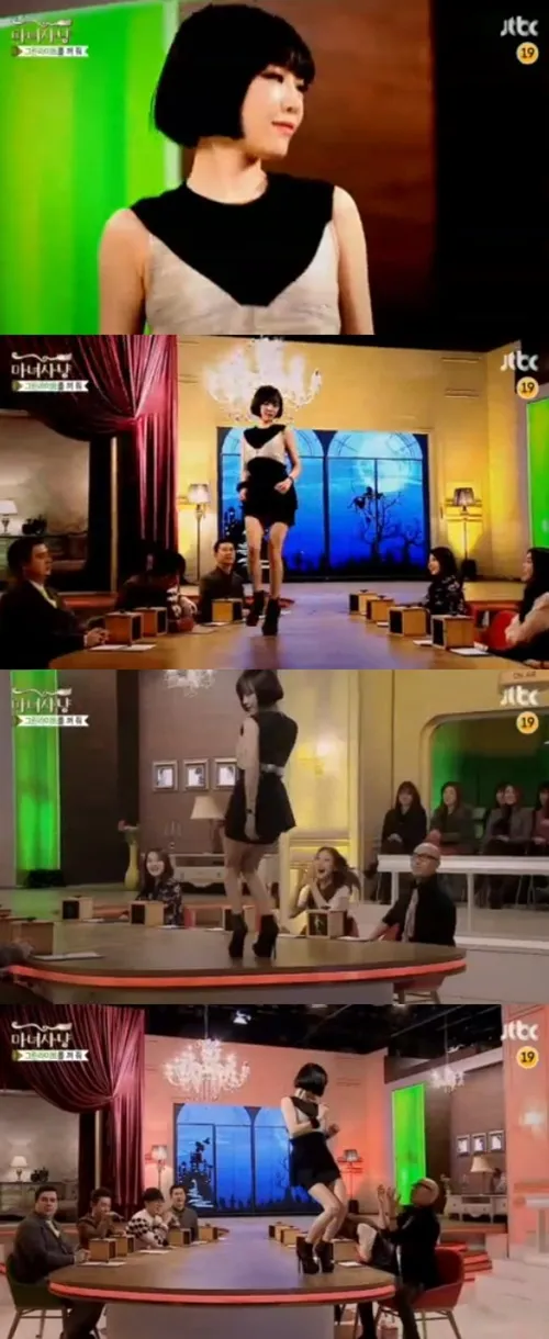 Ga In melakukan gerakan dance di atas meja dengan menggoda. ©soompi