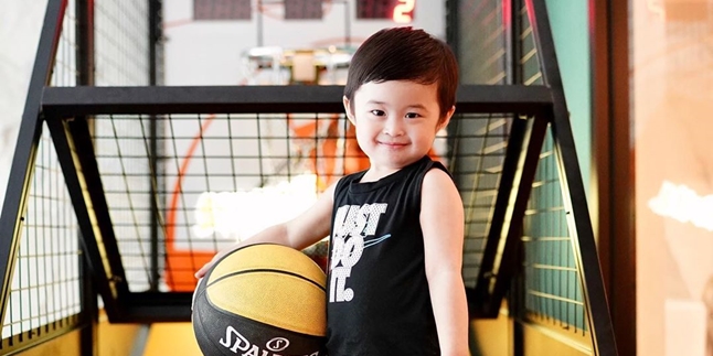 Portrait of Raphael Moeis, Son of Sandra Dewi, Helping the House Assistant Clean the House