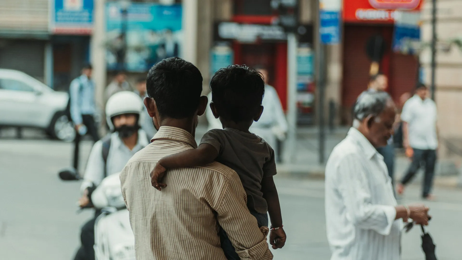 Seorang pria menggendong anak kecil (credit: Unsplash)