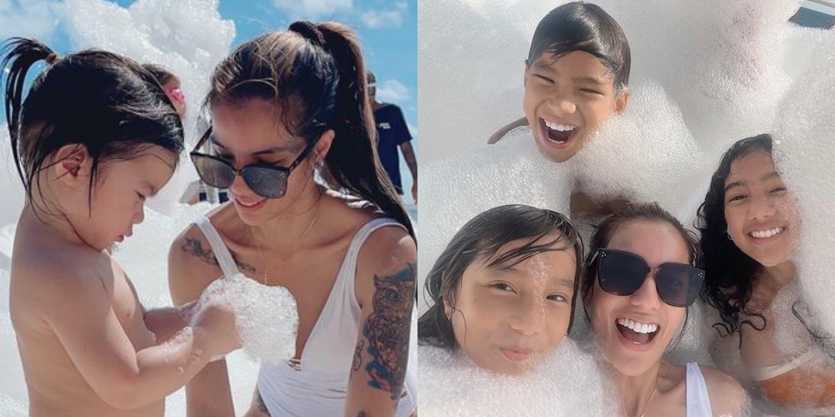 Portrait of Sheila Marcia Looking Beautiful in a Swimsuit, Bathing with Foam While Caring for Her Child