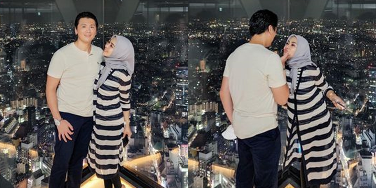 Portrait of Syahrini and Reino Barack on the Rooftop, Exchanging Affectionate Glances under the Japanese Night Sky