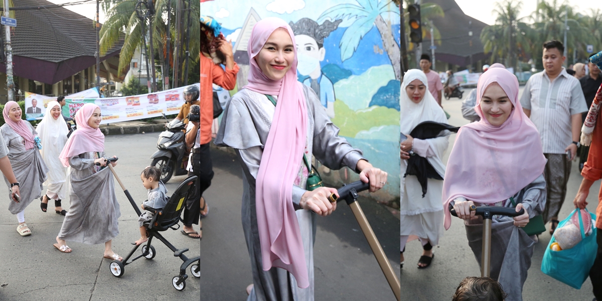 Looking Beautiful with Hijab, Ayu Ting Ting's Portrait Returning from Eid al-Adha Prayer while Babysitting Her Nephew