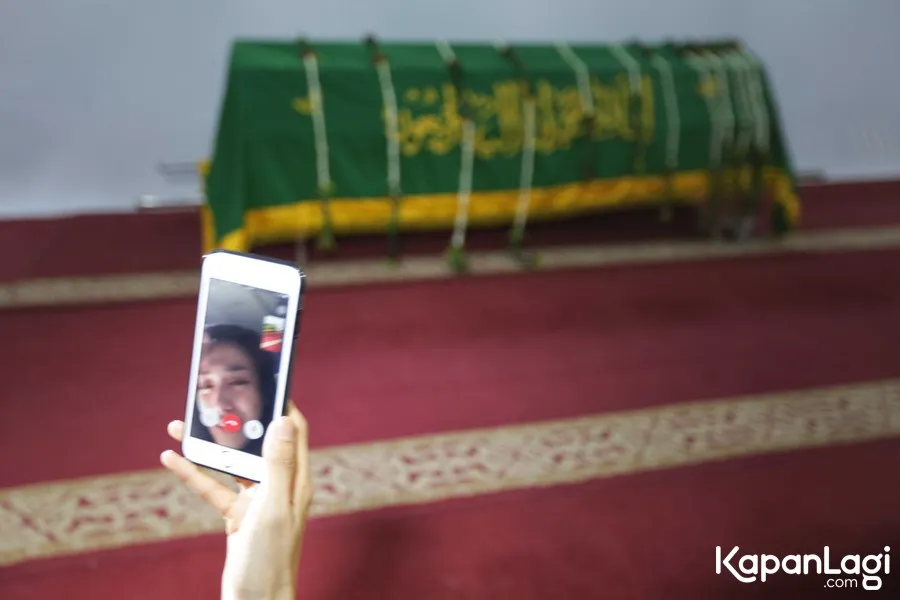 Ririn Ekawati mengikuti sebagian prosesi pemakaman sang suami lewat facetime. ©KapanLagi.com/Budy Santoso