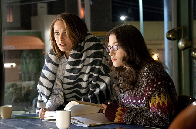 Darcy Lewis (wearing glasses) played by Kat Dennings with Jane Foster played by Natalie Portman in the film THOR (2011)