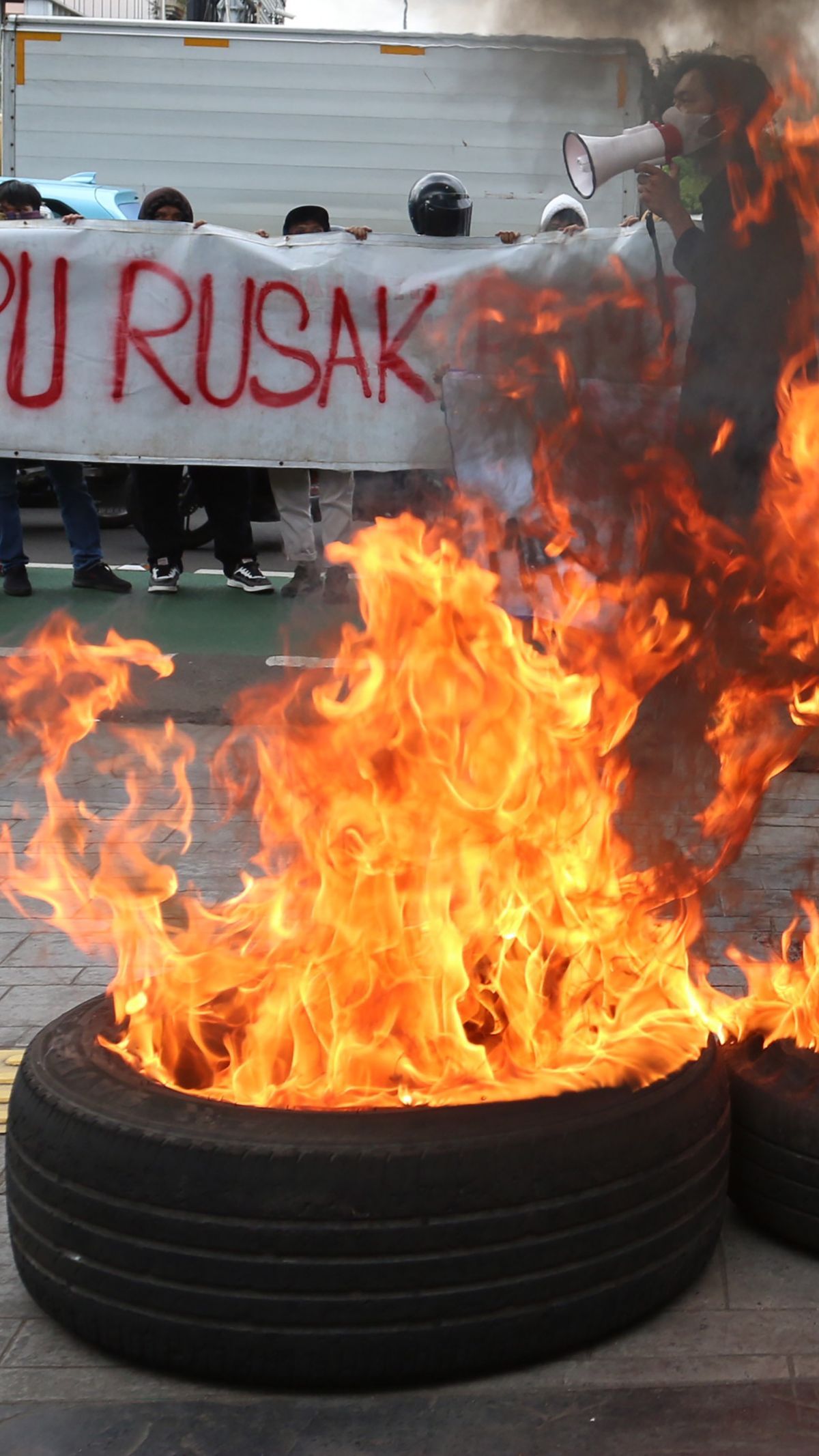 FOTO: Protes Kecurangan Pemilu, Massa Bakar Ban dan Caleg Bikin Laporan di Bawaslu DKI