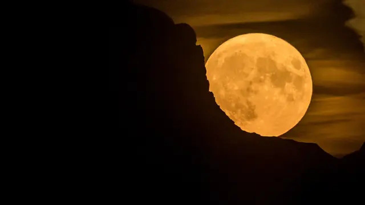 Bulan super purnama, muncul di balik gunung di Pegunungan Alpen Swiss, terlihat dari Chexbres, Swiss barat, Rabu (13/7/2022). Bulan Purnama dikenal sebagai Buck Moon dan juga Supermoon. Di ko