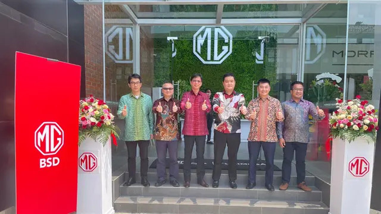 CEO MG Motor Indonesia, He Guowei beserta jajarannya dan Chief Operating Officer PT Mimosa Abadi, Darius Syahputra beserta jajarannya, berfoto bersama dalam pembukaan dealer baru berstatus fl