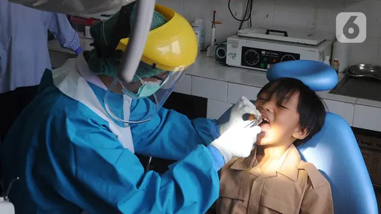 Dokter mencabut gigi murid baru sekolah dasar negeri di Puskesmas Pondok Labu, Jakarta Selatan, Rabu (12/8/2020). Selain dalam rangka Bulan Imunisasi Anak Sekolah, kegiatan ini juga bagian da