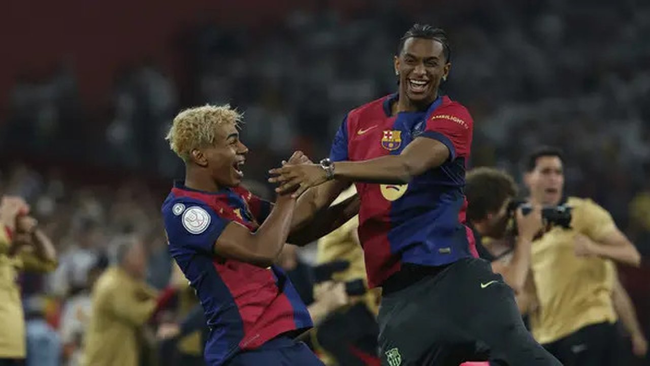 Dua pemain Barcelona, Lamine Yamal dan Alejandro Balde, merayakan keberhasilan tim mereka menjuarai Copa del Rey 2024/2025 setelah mengalahkan Real Madrid dengan skor 3-2 di pertandingan fina