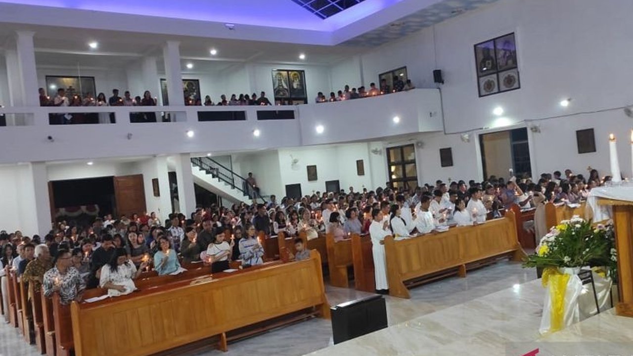 Meskipun Gereja Paroki Bunda Hati Kudus Yesus Rumengkor rusak parah akibat gempa, ratusan umat Katolik di Minahasa tetap khusyuk mengikuti Misa Malam Paskah, menunjukkan iman yang teguh.