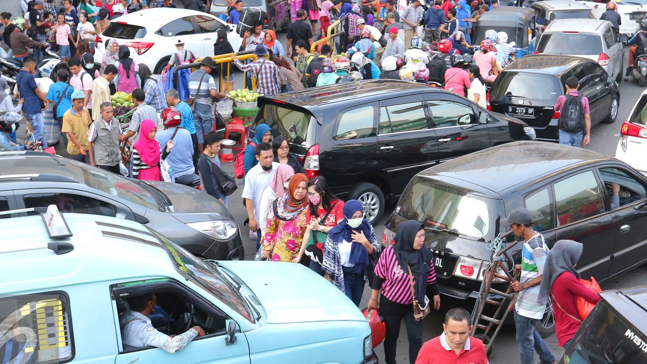 Sejumlah pejalan kaki berjalan di Tanah Abang Jakarta, Sabtu (25/6). Kemacetan tersebut terjadi akibat banyaknya masyarakat yang ingin berbelanja di pasar Tanah Abang untuk memenuhi kebutuhan Idul Fitri. (Liputan6.com/Angga Yuniar)