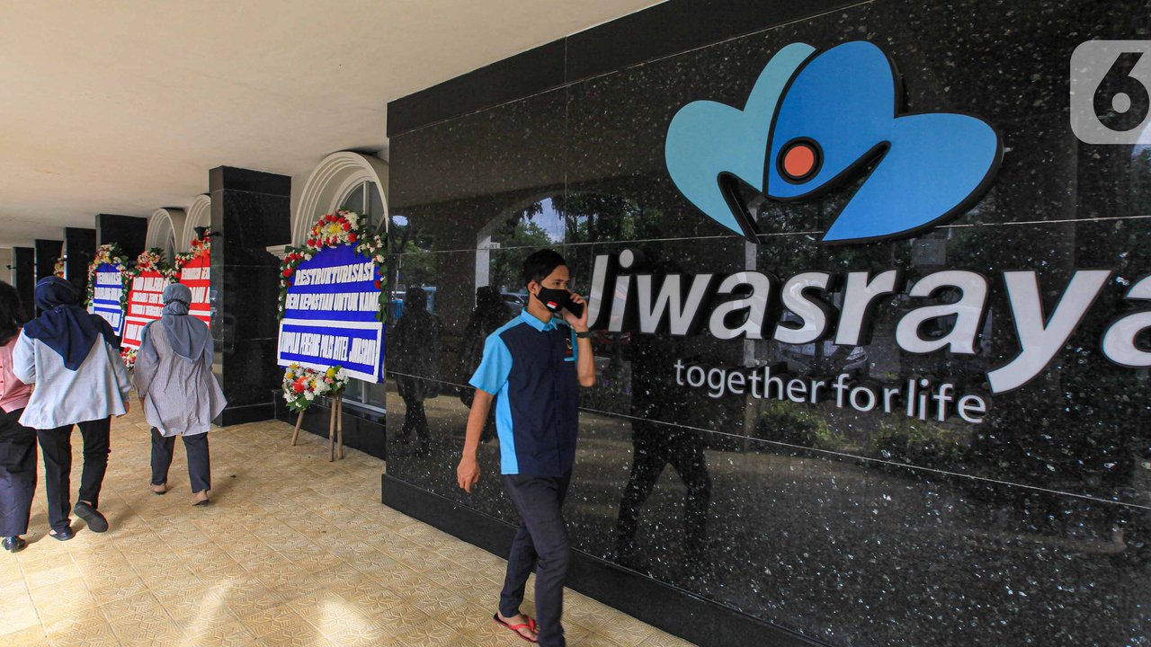 Sejumlah orang berjalan dekat karangan bunga di halaman Kantor PT Asuransi Jiwasraya (Persero), Jakarta, Selasa (15/12/2020). Karangan bunga tersebut berisi ucapan dukungan kepada manajemen baru Jiwasraya dalam penyelamatan polis melalui program restrukturisasi. (Liputan6.com/Faizal Fanani)