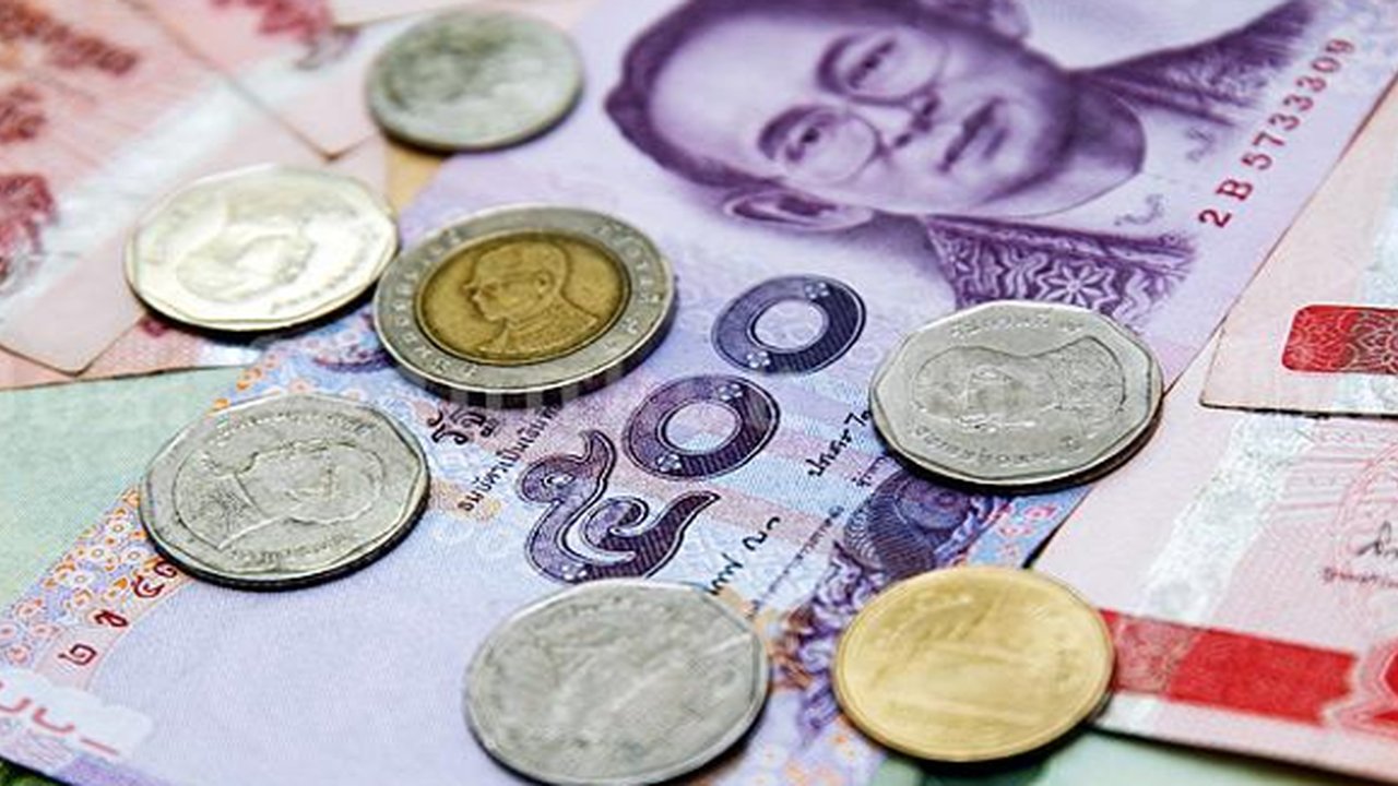 Mata Uang Baht. (Foto: Lillian Suwanrumpha / AFP Photo)