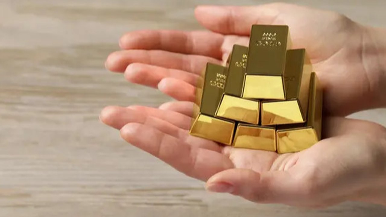 Petugas menunjukan emas batangan di kantor BNI Syariah, Jakarta, Senin (30/11). Harga jual-beli kembali (buyback) emas Antam turun Rp 1.000 usai akhir pekan kemarin naik di tengah turunnya ha