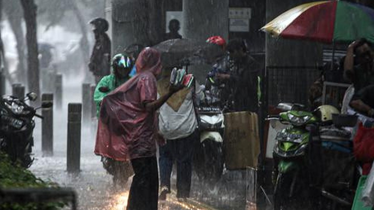 Aktivitas warga saat hujan deras di kawasan Jalan Sudirman, Jakarta, Jumat (9/12/2022). Penjabat Gubernur DKI Jakarta Heru Budi Hartono menyebut pihaknya akan mengkaji penerapan bekerja dari