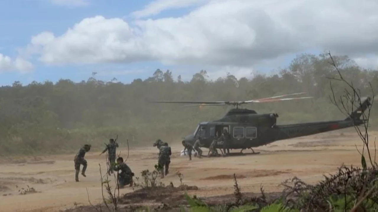 Prajurit TNI AD saat mendistribusikan bantuan kemanusiaan warga terdampak bencana Sumatera di Desa Pagaran Lambung 1, Kecamatan Adian Koting, Tapanuli Utara, Sumatra Utara.