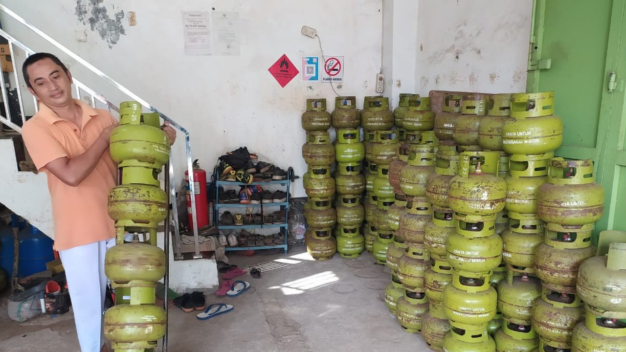 Ramdani (45), salah seorang pemilik pangkalan Gas LPG di Garut, Jawa Barat tengah memindahkan tabung gas di lokasi penyimpanan. (Liputan6.com/Jayadi Supriadin)