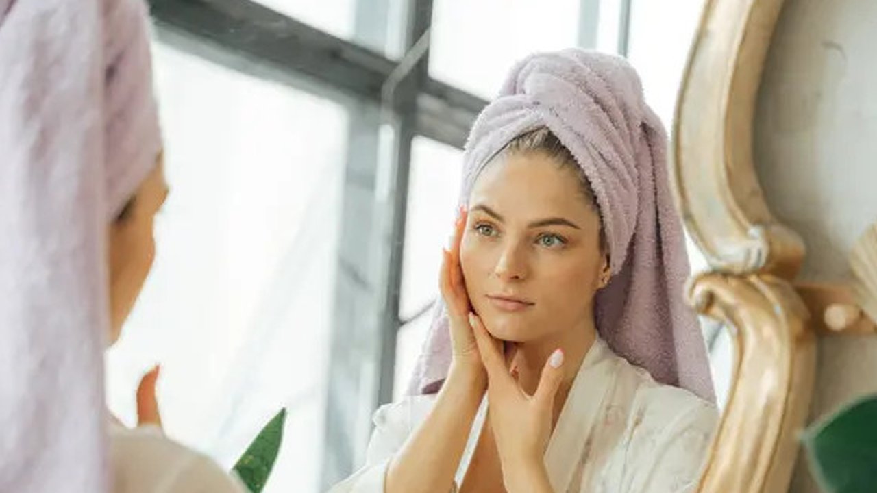 Ilustrasi perempuan mengaplikasikan skincare yang bagus untuk pemilik wajah berminyak dan kusam. Credit: pexels.com by Antoni Shkraba