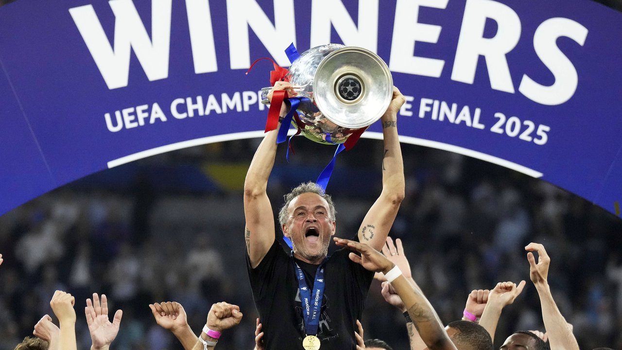 Pelatih PSG, Luis Enrique mengangkat trofi Liga Champions 2024/2025 setelah berhasil mengalahkan Inter Milan dalam laga final yang berlangsung di Allianz Arena, Munchen, Jerman, Minggu (01/06/2025) dini hari WIB. (AP Photo/Matthias Schrader)
