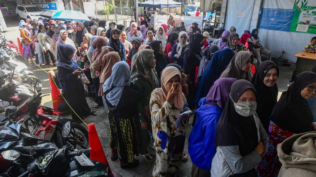 Warga penerima Kartu Jakarta Pintar (KJP) mengantre untuk membeli sembako bersubsidi di mini market Kawasan Duri Kosambi, Jakarta Barat, Selasa (8/7/2025).