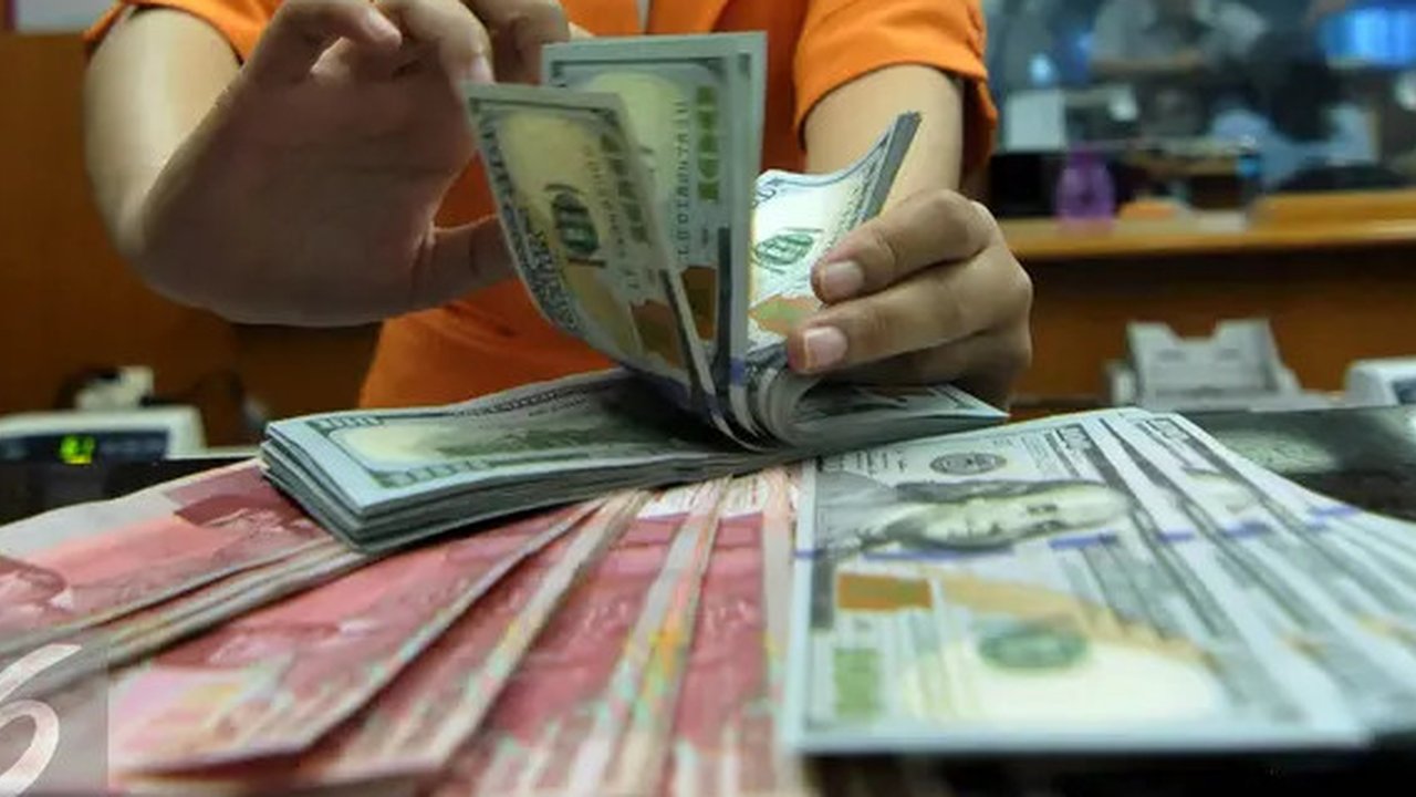 Petugas menghitung uang pecahan US$100 di pusat penukaran uang, Jakarta, , Rabu (12/8/2015). Reshuffle kabinet pemerintahan Jokowi-JK, nilai Rupiah terahadap Dollar AS hingga siang ini menemb