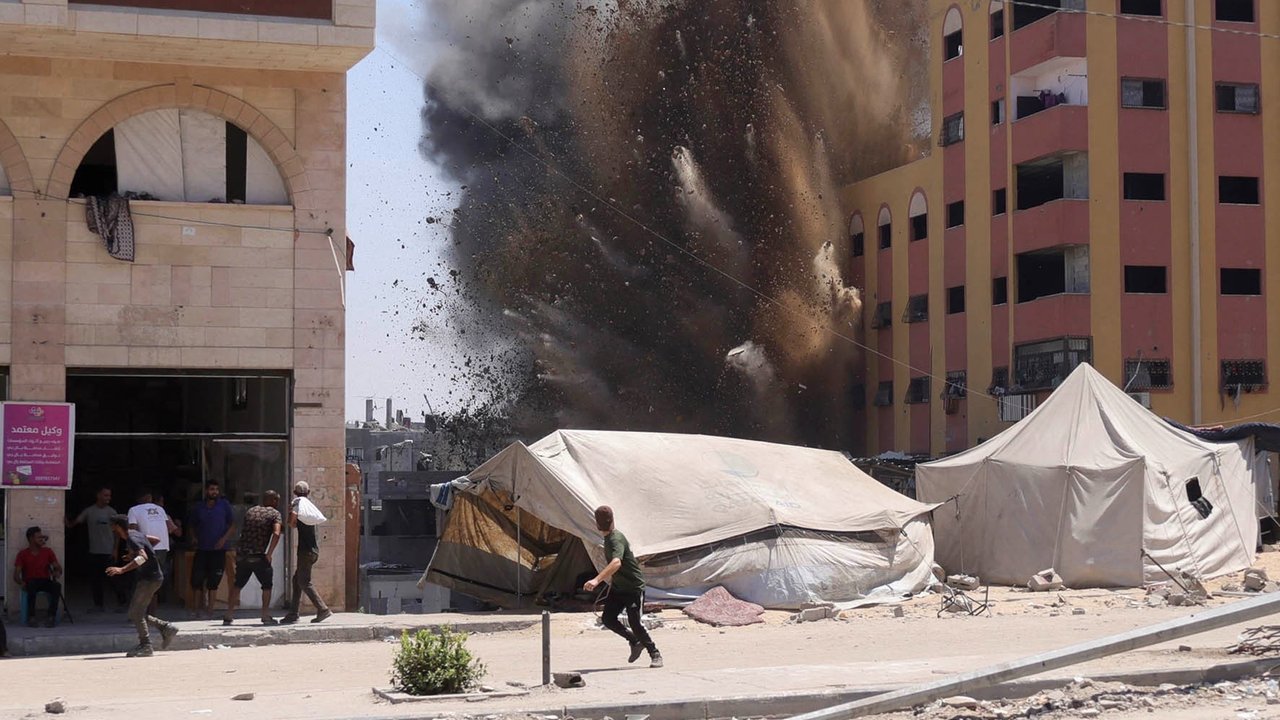 Warga Palestina berlarian saat roket yang ditembakkan pesawat tempur Israel menyasar sebuah gedung di Jabalia, Jalur Gaza utara, Rabu (20/08/2025). 
AFP/ Bashar Taleb