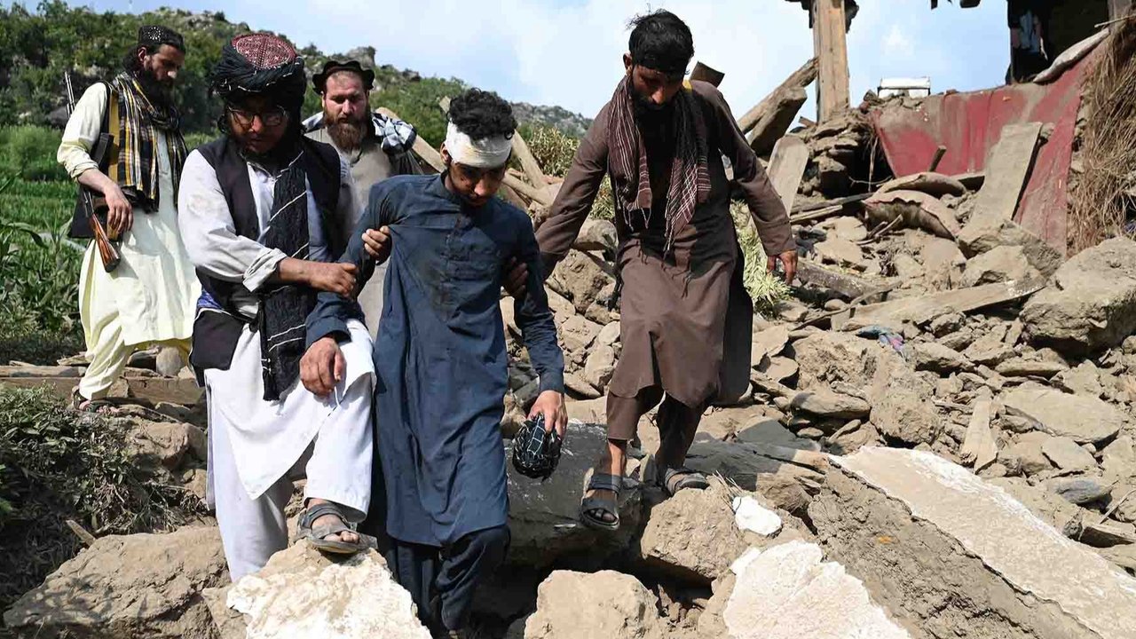 Korban terluka berjalan diantara rumah-rumah yang rusak akibat gempa bumi di desa Mazar Dara, distrik Nurgal, provinsi Kunar, Afghanistan Timur, Senin (01/09/2025).
