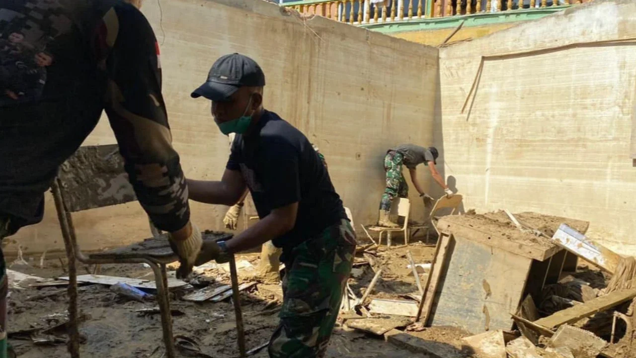Prajurit Yonif 115/Macan Leuser membersihkan lumpur dan sampah sisa banjir di Kantor MPD Kuala Simpang, Aceh Tamiang, guna mempercepat pemulihan fasilitas pelayanan, Sabtu (17/01/2026).