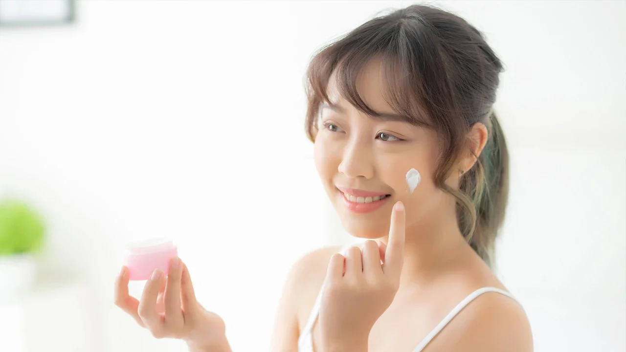 Seorang perempuan menggunakan skincare.