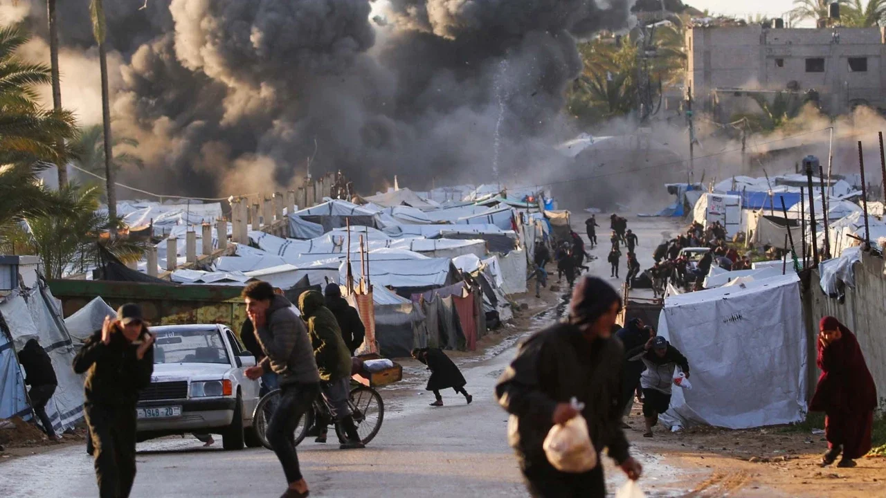 Warga terkejut setelah serangan Israel di dekat perkemahan tenda yang menampung orang-orang yang mengungsi akibat perang di Deir el-Balah di Jalur Gaza tenga,  Rabu (25/03/2026).