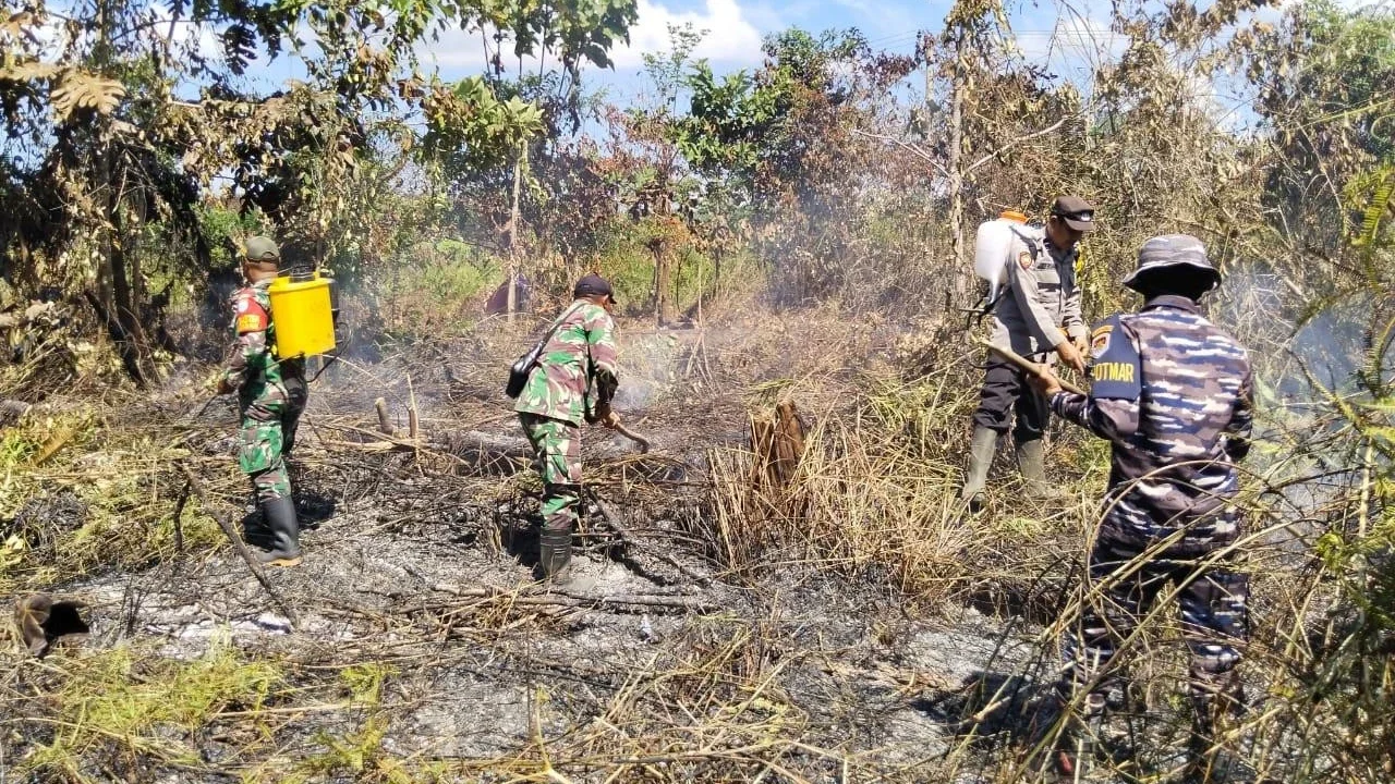 Personel TNI AL bersama tim gabungan memadamkan kebakaran lahan di Dusun Camarbulan Desa Temajuk Kecamatan Paloh Kabupaten Sambas, Kalimantan Barat,  Rabu (06/04/2026).