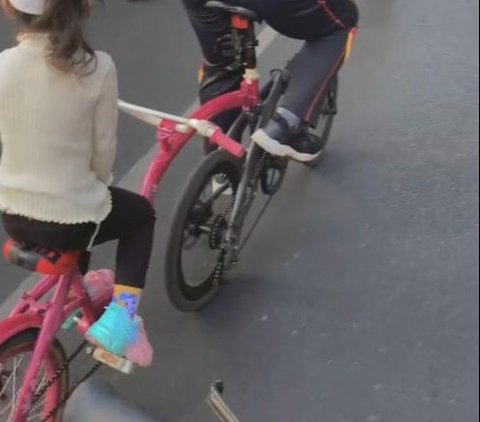 So Sweet, Father Rides His Bike with His Daughter's Pink Bike