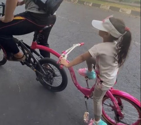 So Sweet, Father Rides His Bike with His Daughter's Pink Bike