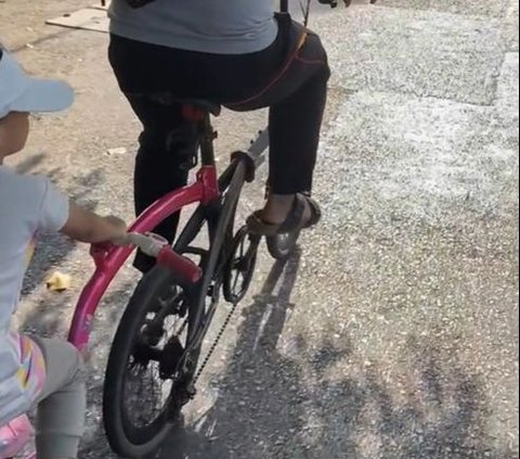 So Sweet, Father Rides His Bike with His Daughter's Pink Bike