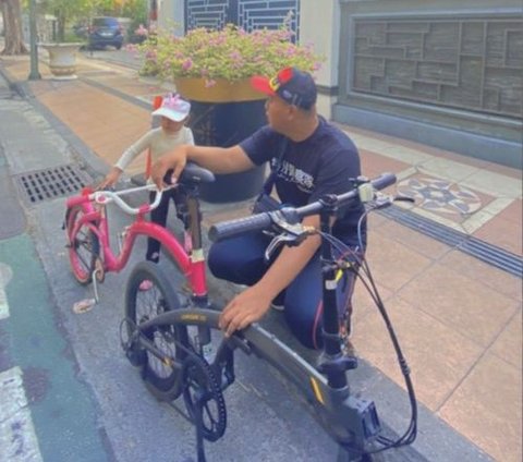 So Sweet, Father Rides His Bike with His Daughter's Pink Bike