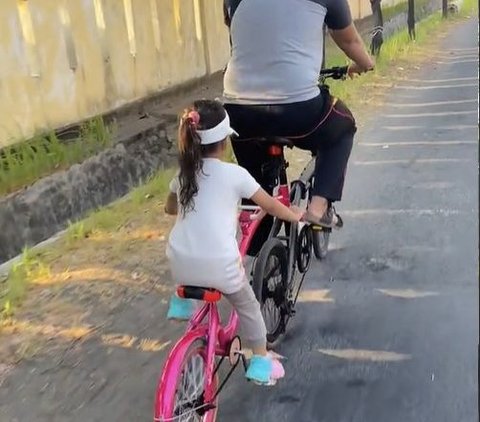 So Sweet, Father Rides His Bike with His Daughter's Pink Bike