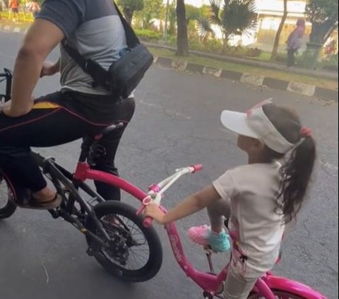 So Sweet, Father Rides His Bike with His Daughter's Pink Bike