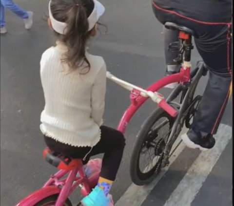 So Sweet, Father Rides His Bike with His Daughter's Pink Bike