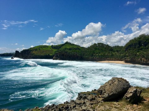 Chasing the Moment of Waves Crashing Against the Cliff at the Popular Travel Spot Widodaren Beach