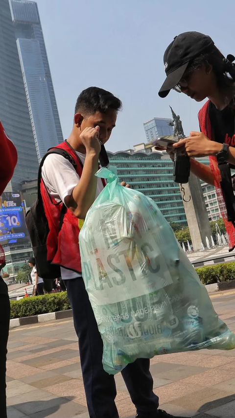 Pegiat peduli lingkungan menimbang sampah plastik yang berhasil dikumpulkan saat CFD di kawasan Bundaran HI, Jakarta.