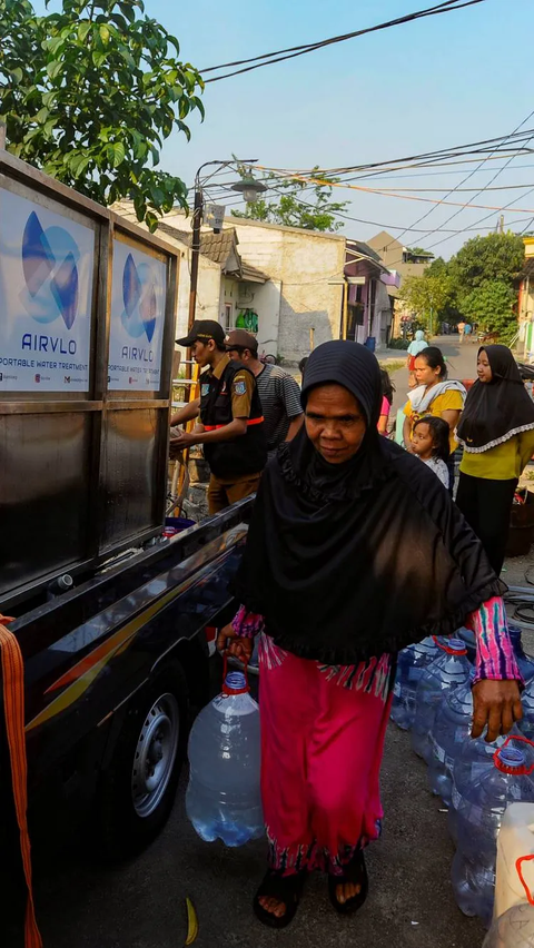 Warga membawa pulang air bersih usai mendapatkan bantuan dari Badan Penanggulangan Bencana Daerah (BPBD) Tangerang Selatan.